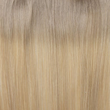 Load image into Gallery viewer, Close-up of blonde hair extensions with a gradient from light to dark.