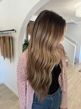 Load image into Gallery viewer, Woman with long, wavy hair in a stylish interior setting
